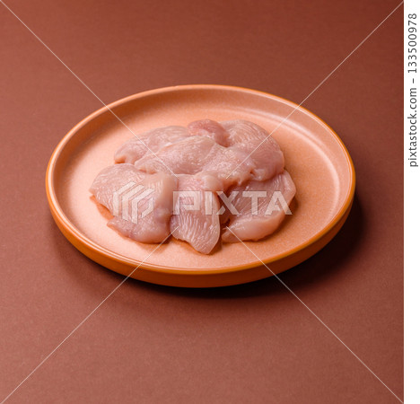 Slices of raw chicken or turkey breast, skinless and boneless. Chicken breast slices Slices of raw chicken or turkey breast, skinless and boneless. Chicken breast slices 133500978