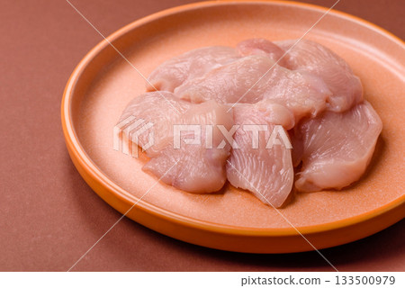 Slices of raw chicken or turkey breast, skinless and boneless. Chicken breast slices Slices of raw chicken or turkey breast, skinless and boneless. Chicken breast slices 133500979