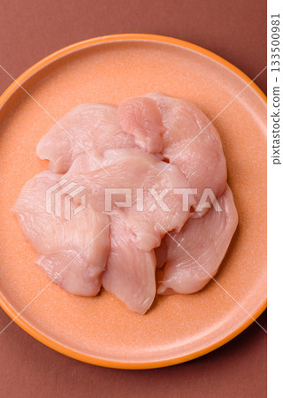 Slices of raw chicken or turkey breast, skinless and boneless. Chicken breast slices 133500981