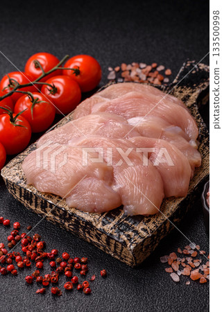 Slices of raw chicken or turkey breast, skinless and boneless. Chicken breast slices Slices of raw chicken or turkey breast, skinless and boneless. Chicken breast slices 133500998