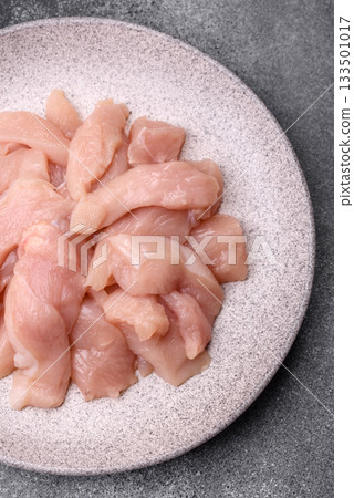 Strips of raw chicken or turkey fillet, skinless and boneless poultry breast. Chicken fillet strips 133501017