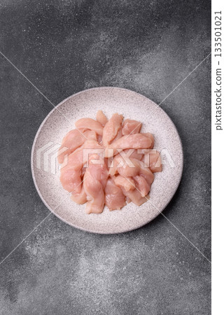 Strips of raw chicken or turkey fillet, skinless and boneless poultry breast. Chicken fillet strips Strips of raw chicken or turkey fillet, skinless and boneless poultry breast. Chicken fillet strips 133501021