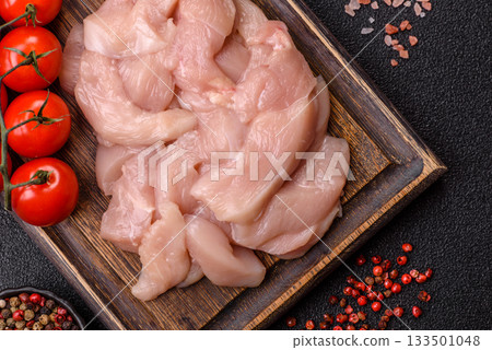 Strips of raw chicken or turkey fillet, skinless and boneless poultry breast. Chicken fillet strips Strips of raw chicken or turkey fillet, skinless and boneless poultry breast. Chicken fillet strips 133501048