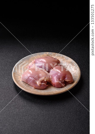 Raw chicken thigh fillet, poultry meat as a source of protein. Chicken thigh fillet Raw chicken thigh fillet, poultry meat as a source of protein. Chicken thigh fillet 133501275