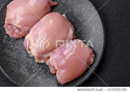 Raw chicken thigh fillet, poultry meat as a source of protein. Chicken thigh fillet Raw chicken thigh fillet, poultry meat as a source of protein. Chicken thigh fillet 133501295