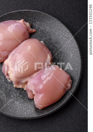 Raw chicken thigh fillet, poultry meat as a source of protein. Chicken thigh fillet Raw chicken thigh fillet, poultry meat as a source of protein. Chicken thigh fillet 133501296