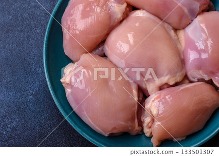 Raw chicken thigh fillet, poultry meat as a source of protein. Chicken thigh fillet Raw chicken thigh fillet, poultry meat as a source of protein. Chicken thigh fillet 133501307
