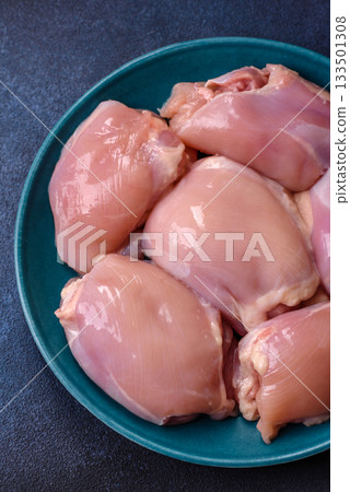 Raw chicken thigh fillet, poultry meat as a source of protein. Chicken thigh fillet 133501308