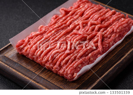Raw ground beef or pork, prepared meat for burgers or other food preparation. Raw ground beef 133501339