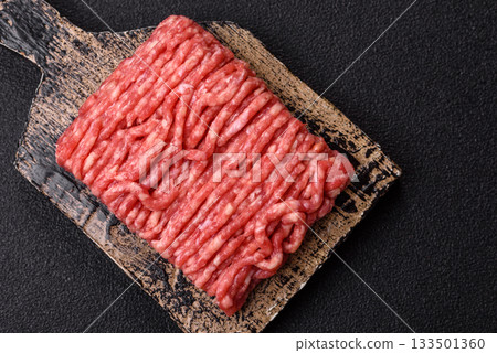 Raw ground beef or pork, prepared meat for burgers or other food preparation. Raw ground beef 133501360