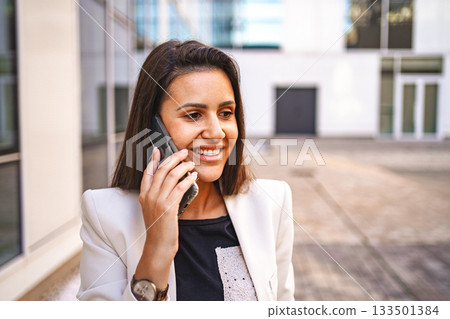 Businesswoman talking on a phone after work Businesswoman talking on a phone after work 133501384