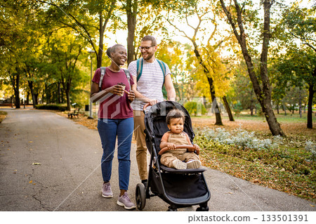 Family stroll through a vibrant park on a sunny autumn day 133501391
