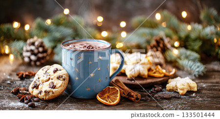 A Christmas scene with a hot drink in a blue mug, decorations and cookies 133501444