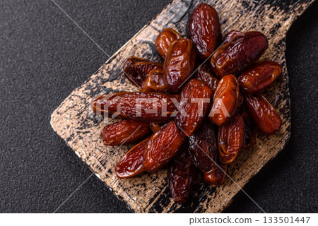 Dried dates in a ceramic plate, arabic food for the ramadan table. Dried dates as a food backgrounds Dried dates in a ceramic plate, arabic food for the ramadan table. Dried dates as a food backgrounds 133501447