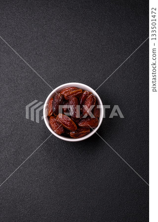 Dried dates in a ceramic plate, arabic food for the ramadan table. Dried dates as a food backgrounds Dried dates in a ceramic plate, arabic food for the ramadan table. Dried dates as a food backgrounds 133501472