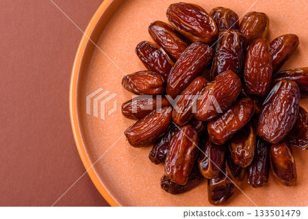 Dried dates in a ceramic plate, arabic food for the ramadan table. Dried dates as a food backgrounds 133501479