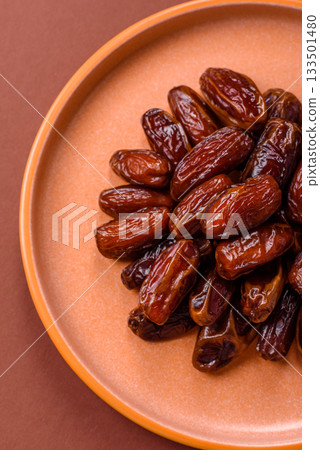 Dried dates in a ceramic plate, arabic food for the ramadan table. Dried dates as a food backgrounds 133501480