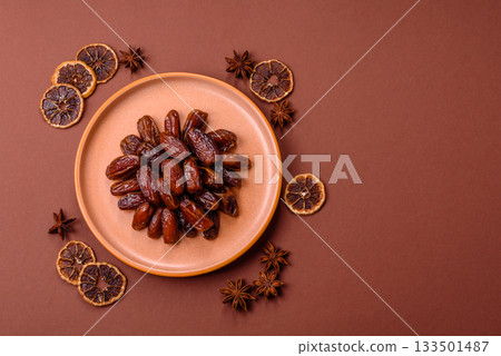 Dried dates in a ceramic plate, arabic food for the ramadan table. Dried dates as a food backgrounds Dried dates in a ceramic plate, arabic food for the ramadan table. Dried dates as a food backgrounds 133501487