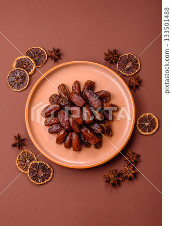 Dried dates in a ceramic plate, arabic food for the ramadan table. Dried dates as a food backgrounds Dried dates in a ceramic plate, arabic food for the ramadan table. Dried dates as a food backgrounds 133501488