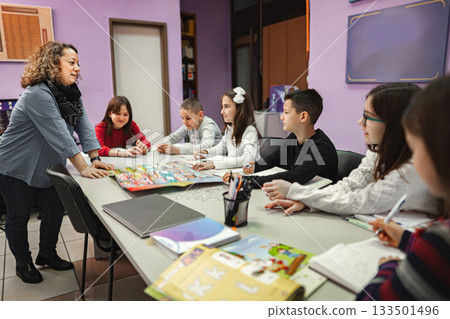 Woman teaching a group of elementary students at language school 133501496