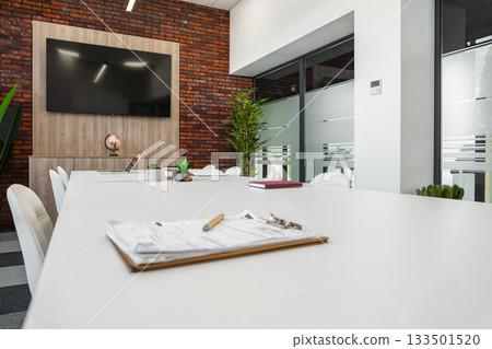 Modern Conference Room With Large Windows and Flat Screen TV 133501520