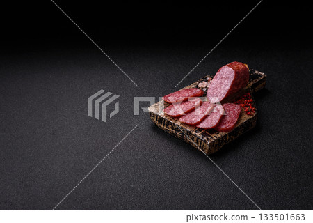 Sliced salami sausage, smoked meat as a delicacy for the table. Salami sausage Sliced salami sausage, smoked meat as a delicacy for the table. Salami sausage 133501663