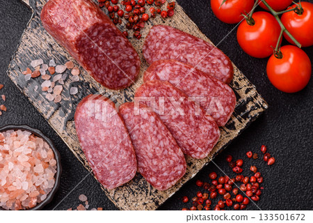Sliced salami sausage, smoked meat as a delicacy for the table. Salami sausage Sliced salami sausage, smoked meat as a delicacy for the table. Salami sausage 133501672