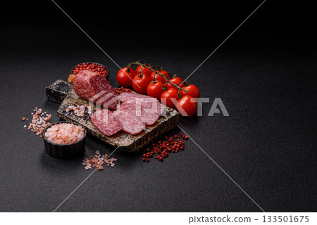 Sliced salami sausage, smoked meat as a delicacy for the table. Salami sausage Sliced salami sausage, smoked meat as a delicacy for the table. Salami sausage 133501675