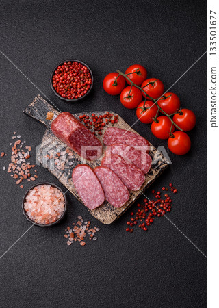 Sliced salami sausage, smoked meat as a delicacy for the table. Salami sausage Sliced salami sausage, smoked meat as a delicacy for the table. Salami sausage 133501677