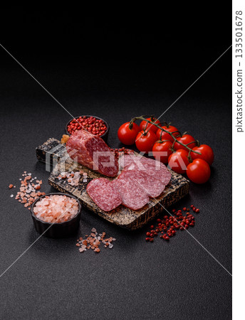 Sliced salami sausage, smoked meat as a delicacy for the table. Salami sausage Sliced salami sausage, smoked meat as a delicacy for the table. Salami sausage 133501678