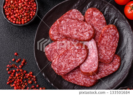 Sliced salami sausage, smoked meat as a delicacy for the table. Salami sausage Sliced salami sausage, smoked meat as a delicacy for the table. Salami sausage 133501684