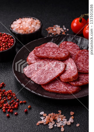 Sliced salami sausage, smoked meat as a delicacy for the table. Salami sausage Sliced salami sausage, smoked meat as a delicacy for the table. Salami sausage 133501686