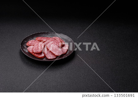 Sliced salami sausage, smoked meat as a delicacy for the table. Salami sausage 133501691