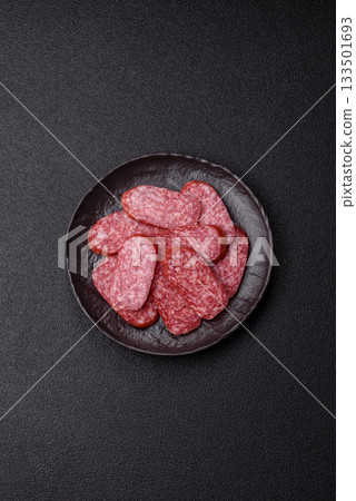 Sliced salami sausage, smoked meat as a delicacy for the table. Salami sausage Sliced salami sausage, smoked meat as a delicacy for the table. Salami sausage 133501693