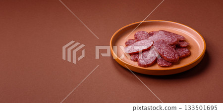 Sliced salami sausage, smoked meat as a delicacy for the table. Salami sausage 133501695