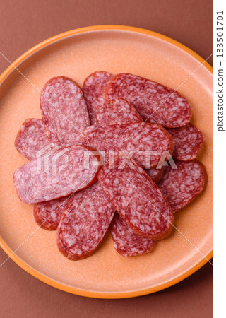 Sliced salami sausage, smoked meat as a delicacy for the table. Salami sausage 133501701