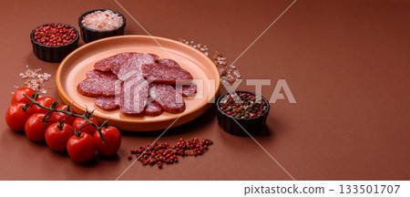 Sliced salami sausage, smoked meat as a delicacy for the table. Salami sausage Sliced salami sausage, smoked meat as a delicacy for the table. Salami sausage 133501707