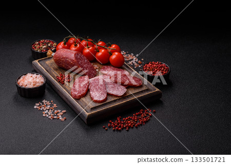 Sliced salami sausage, smoked meat as a delicacy for the table. Salami sausage Sliced salami sausage, smoked meat as a delicacy for the table. Salami sausage 133501721