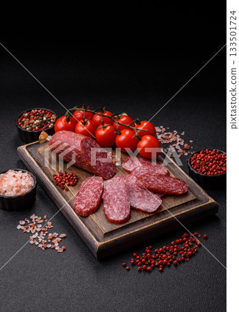 Sliced salami sausage, smoked meat as a delicacy for the table. Salami sausage Sliced salami sausage, smoked meat as a delicacy for the table. Salami sausage 133501724