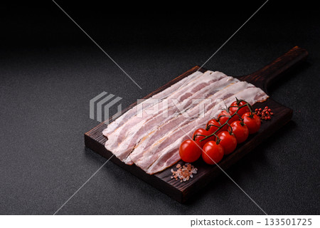 Raw or smoked pork bacon slices or strips as a breakfast ingredient. Raw bacon Raw or smoked pork bacon slices or strips as a breakfast ingredient. Raw bacon 133501725