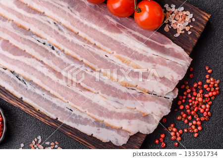 Raw or smoked pork bacon slices or strips as a breakfast ingredient. Raw bacon 133501734