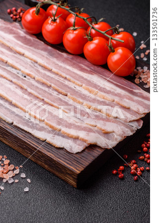 Raw or smoked pork bacon slices or strips as a breakfast ingredient. Raw bacon 133501736