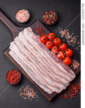 Raw or smoked pork bacon slices or strips as a breakfast ingredient. Raw bacon 133501738