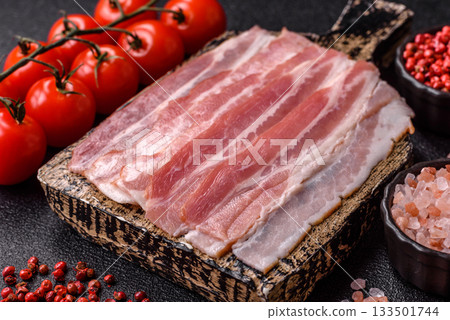 Raw or smoked pork bacon slices or strips as a breakfast ingredient. Raw bacon 133501744