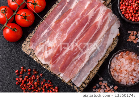 Raw or smoked pork bacon slices or strips as a breakfast ingredient. Raw bacon 133501745