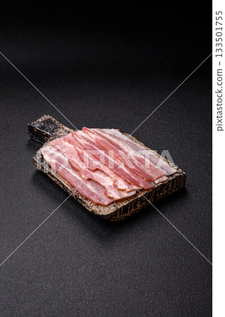 Raw or smoked pork bacon slices or strips as a breakfast ingredient. Raw bacon 133501755