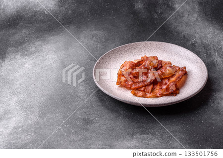 Fried pork bacon slices or strips as a breakfast ingredient. Fried bacon 133501756