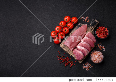 Raw pork tenderloin, sliced, is fresh meat, a source of protein. Pork tenderloin Raw pork tenderloin, sliced, is fresh meat, a source of protein. Pork tenderloin 133502205