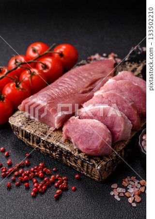 Raw pork tenderloin, sliced, is fresh meat, a source of protein. Pork tenderloin 133502210
