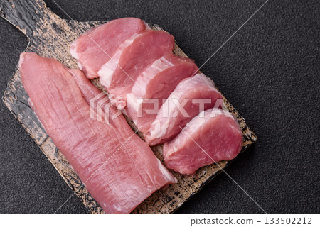 Raw pork tenderloin, sliced, is fresh meat, a source of protein. Pork tenderloin Raw pork tenderloin, sliced, is fresh meat, a source of protein. Pork tenderloin 133502212